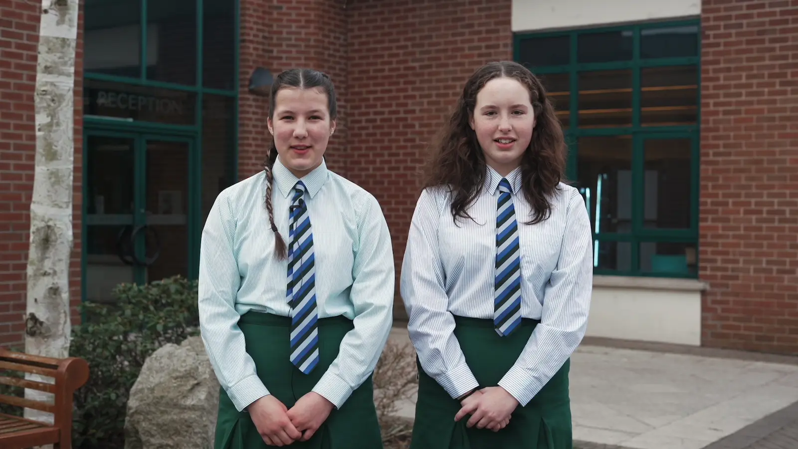 pupils standing outside school building